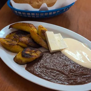 Plátanos fritos with beans, Salvadorian cheese and crema, and a bolillo bread. So delicious!