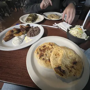 We ordered a mixed pupusa, carne asada pupusa, plantains and a pork tamale. Came with a tomato sauce and cabbage slaw as sides.