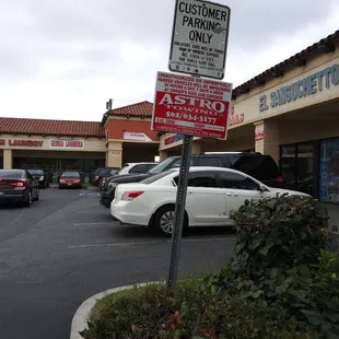 Tow company signs posted in the lot.  This blank corner spot is where my vehicle was towed from.  $308