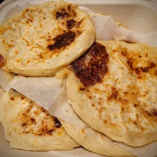 three flatbreads in a container