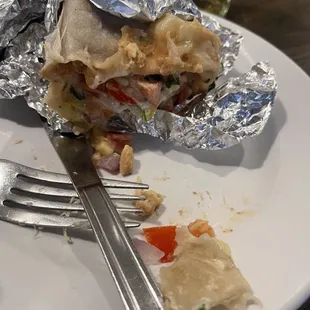 Burrito filled with salsa, tomatoes and onions when we said none of that.