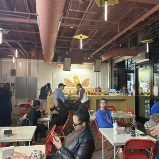 people sitting at tables in a restaurant