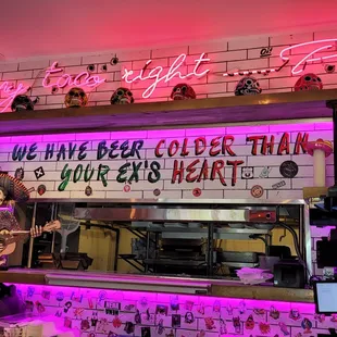 a neon sign above the counter