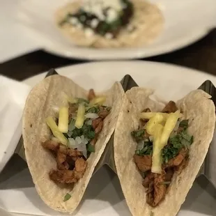two tacoss on a plate