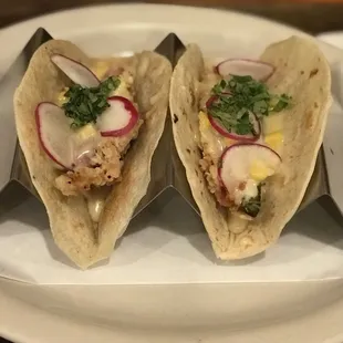 two tacoss on a plate