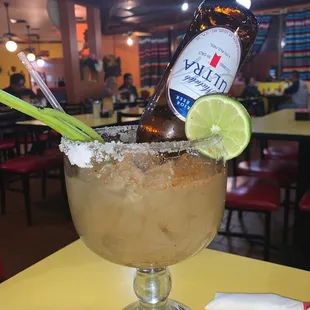 a margarita in a glass with a lime wedge