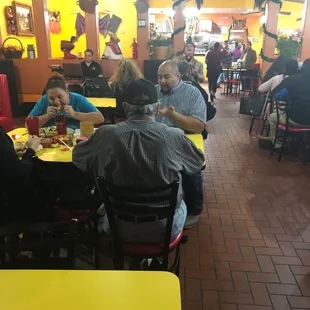a group of people eating in a restaurant
