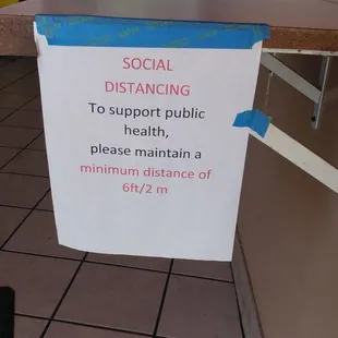 a sign stating social distancing to support public health