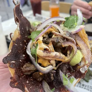 taco el chingon, grilled chihuahua cheese, grilled steak, grilled onions, salsa avocado jalapeño, ranchera salsa and Eagan secret sauce.