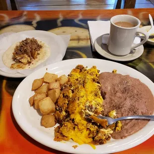 Chorizo Miga plate with a taco on the side and a coffee.