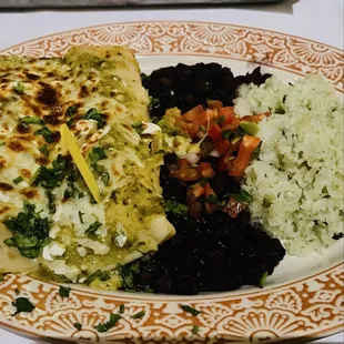 Chicken Tinga Enchiladas smothered in green sauce, served with  Rice &amp; Beans