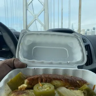 a person holding a container of food