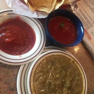 Two different red salsas and delicious hot salsa verde