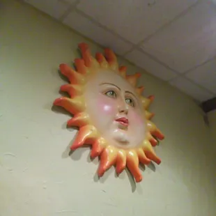 a sun face on the wall