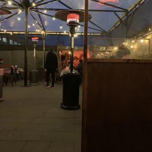 a patio area with tables and umbrellas