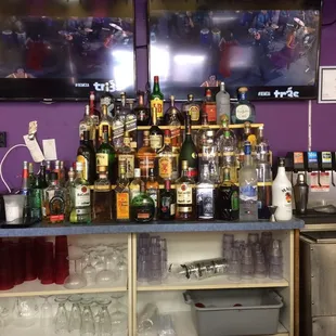 a bar with a lot of alcohol bottles