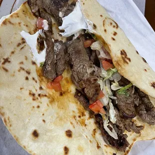 a taco with meat and vegetables