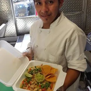 a man holding a tray of food