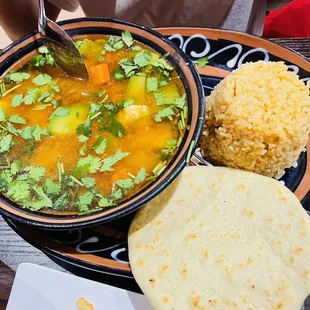 a bowl of soup and a plate of rice