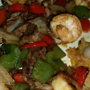 Mar y Tierra steak and shrimp sautéed with sweet onion and peppers.