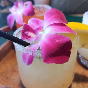 a drink with a flower garnish