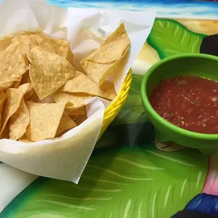 a bowl of salsa and chips