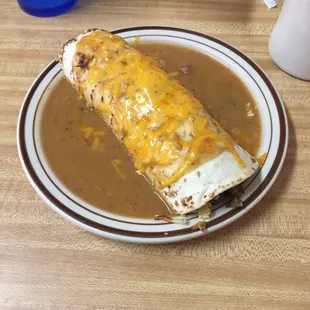 Breakfast burrito smothered in green chili.