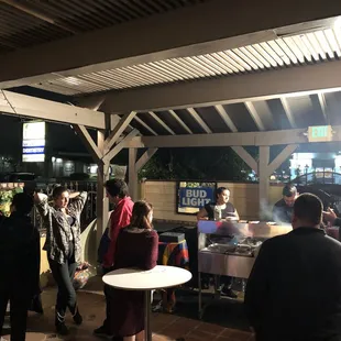 a group of people standing around a table