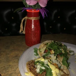 two tacos on a paper plate