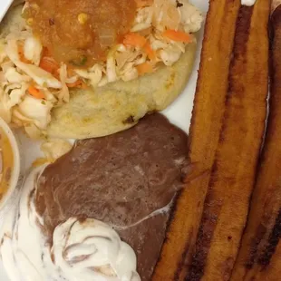 Pupusa with repoyo and spicy salsa. Plantains with frijoles and crema. Both were delicious!