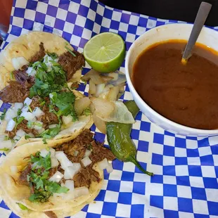 a plate of tacos and a bowl of salsa