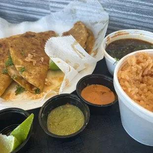 Birria tacos meal comes with 3 tacos and the special juice on the side. beans and rice and the red and green spicey sauce