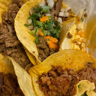 three tacos in a styrofoam container
