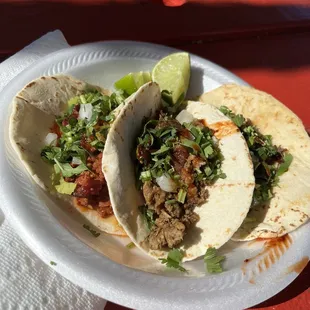 two tacos on a paper plate