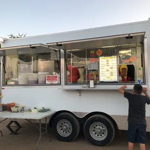 a man standing in front of a food truck