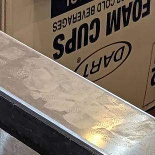 Health Code violation!   Worker standing on food countertop with shoes on for several minutes and never cleaned counter off.