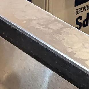 Open food countertop employee standing on with shoes.