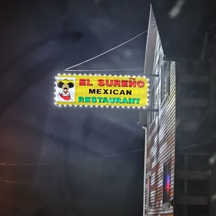 a mexican restaurant sign lit up at night