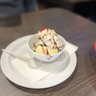 a bowl of ice cream with a strawberry on top