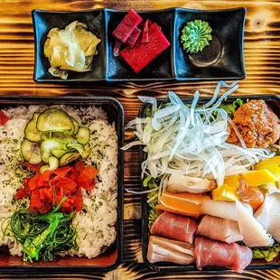 Lunch chirashi with side of pickles, ginger and wasabi.