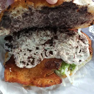 a hand holding a hamburger