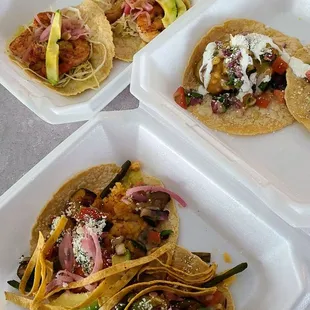 Fried avocado tacos, shrimp tacos, Arabe pork tacos, and vegetarian tacos.