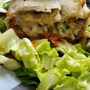 Steak burrito with a melty gooey layer of cheese (i put it on a bed of lettuce and spinach)