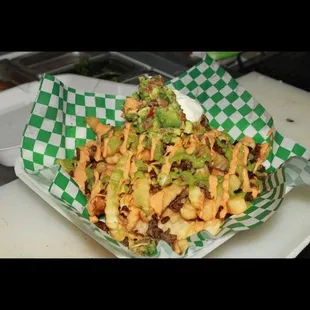 Carne asada fries- Comes with fries, asada, sour cream, guacamole, and two of our special sauces to give it that touch