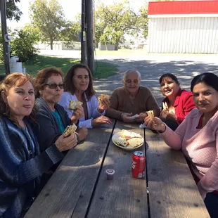 a group of women sitting at a picnic table