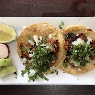 Street tacos. Al pastor. Note the radish and lime and cuke. You need these...