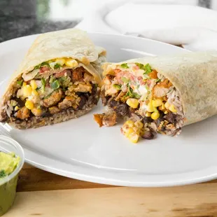 a burrito cut in half on a plate