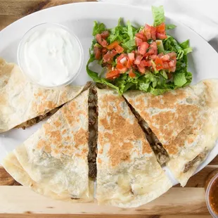 a plate of quesadillas and a salad