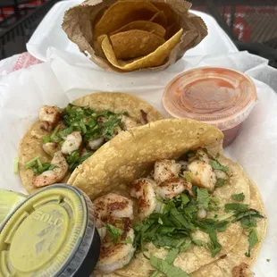 Shrimp tacos with chips and salsa.