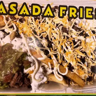 a salad fries in a styrofoam container